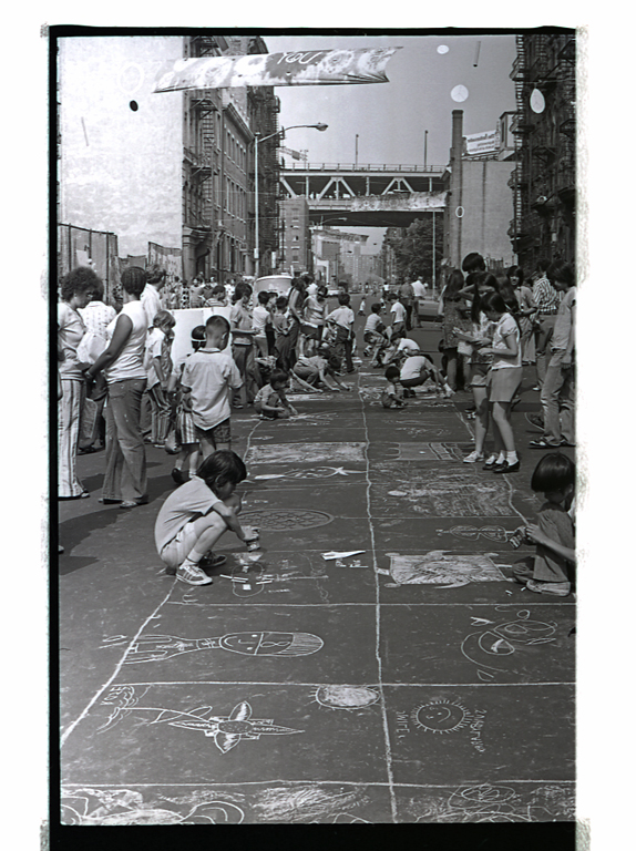 2015.019.062 Children making chalk drawings on the blacktop of Henry Street, July, 1972. Courtesy of Henry Chu, Museum of Chinese in America (MOCA) Collection.