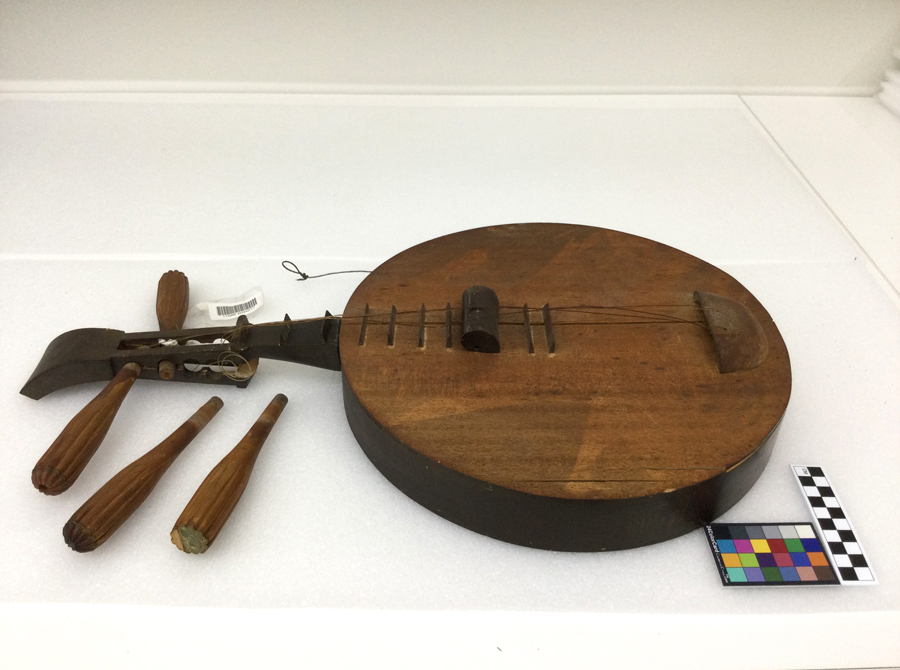 TS6234 Yueqin, a traditional Chinese string instrument used in Cantonese music, and more prominently, in Beijing opera. Photograph taken post-fire. Museum of Chinese in America (MOCA) Chinese Musical and Theatrical Association (CMTA) Collection.