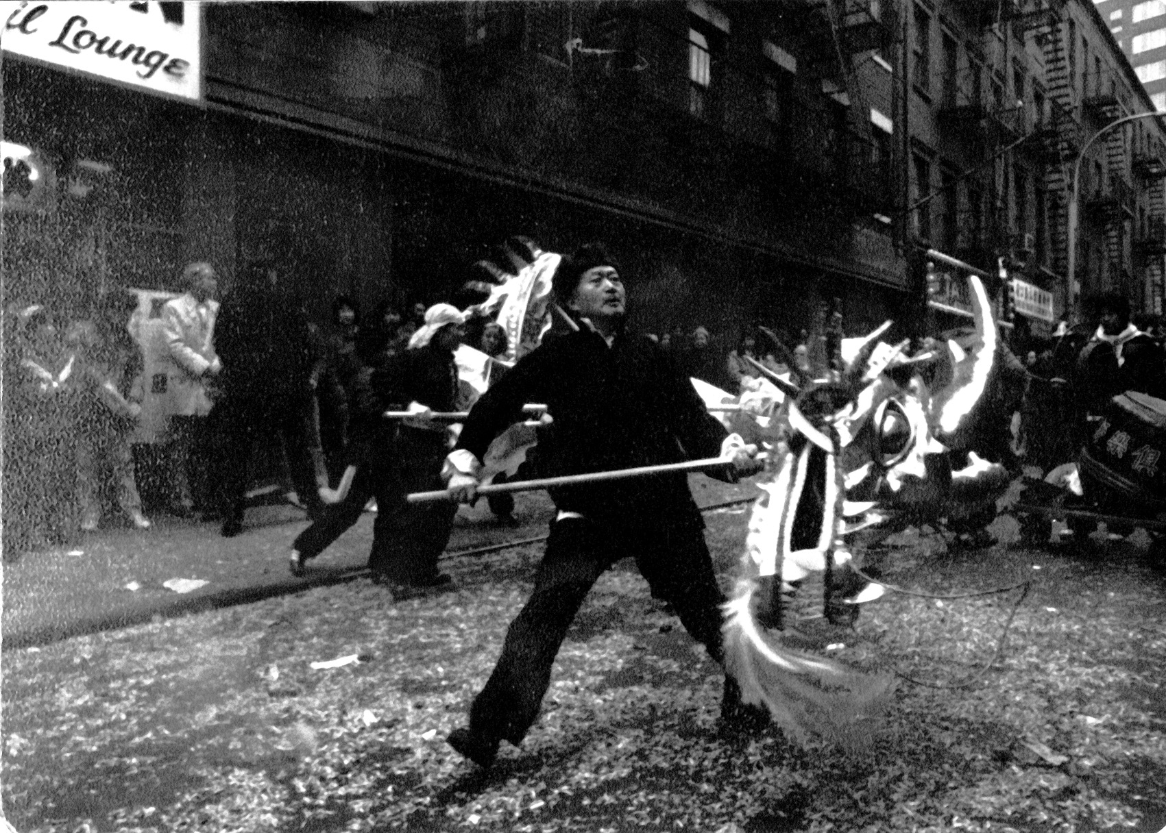 2016.025.004 Shifu Woo Chia Meng with a dragon head during a Chinese New Year celebration in New York's Chinatown in 1977.