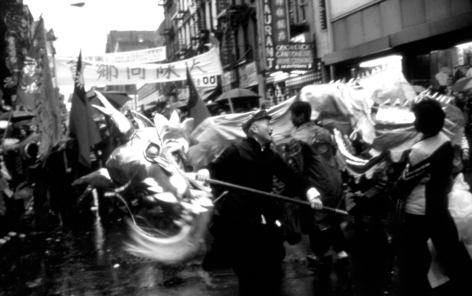 2016.025.005 Shifu Woo Chai Meng holding a dragon head along with members of the New York Honan Shaolin Association's Golden Dragon Team during the 1979 Lunar New Year celebration in New York Chinatown. Photograph taken by Richard Zak. Courtesy of the Honan Shaolin Association, Museum of Chinese in America (MOCA) Collection.