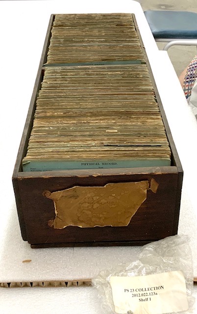 2012.022.123a Wooden drawer containing P.S. 23  boys' student records. Photograph taken post-fire.