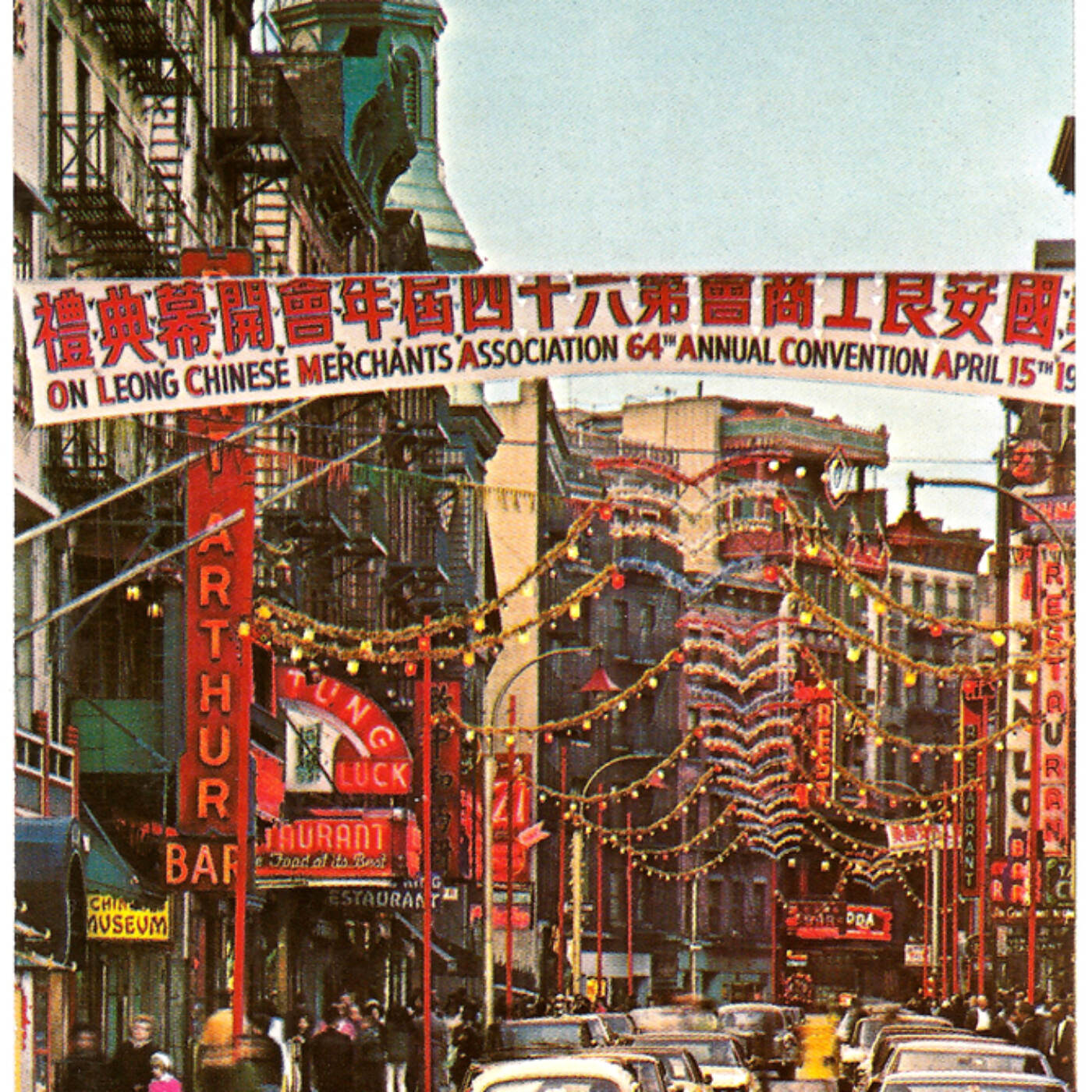 A postcard of Mott Street decorated for the On Leong Chinese Merchants Association 64th Annual Convention with a banner in Chinese and English and lights. The convention took place on April 15, ca. 1960s. Visible business signs include Port Arthur, Chinese Museum, and Tung Luck Restaurant. The Church of Transfiguration is visible in the distance. Courtesy of Eric Y. Ng, Museum of Chinese in America (MOCA) Collection.