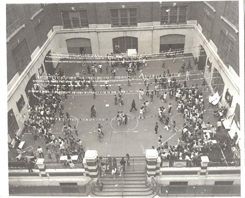 2014.029.594a Aerial view of the schoolyard at JHS 65, where students held a Carnival Day to raise funds for school supplies and physical education equipment, May 26, 1976. Photograph taken by Emile Bocian, Museum of Chinese in America (MOCA) Collection.
