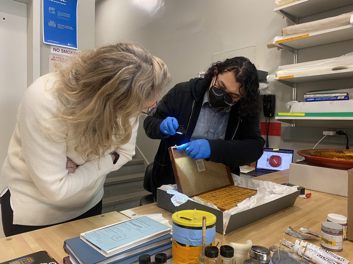 Adrian discussed the treatment methods for the Mahjong set with Rachael. Photograph taken by Yue Ma. 